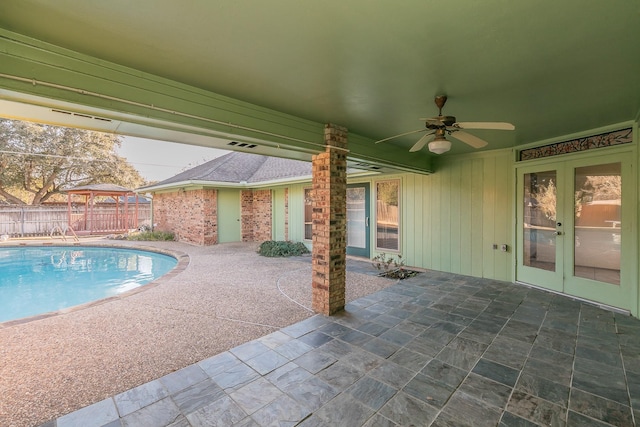 view of swimming pool with a patio, a gazebo, french doors, and ceiling fan