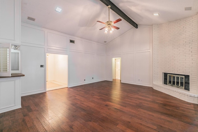 unfurnished living room with dark hardwood / wood-style floors, ceiling fan, a fireplace, and vaulted ceiling with beams