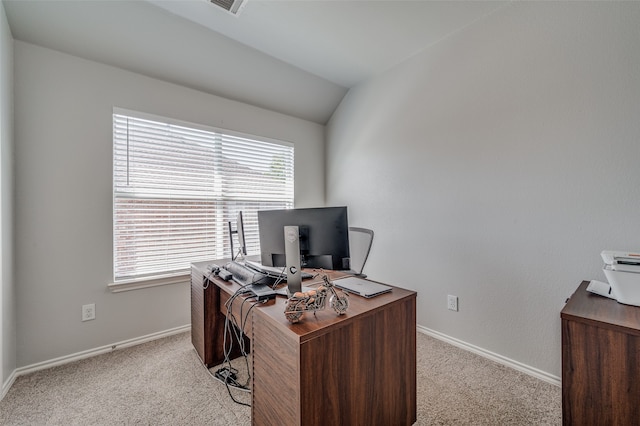 carpeted home office featuring vaulted ceiling