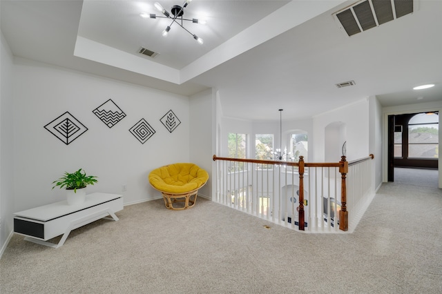 sitting room featuring an inviting chandelier and light carpet