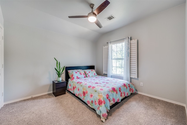 bedroom with vaulted ceiling, ceiling fan, and carpet flooring