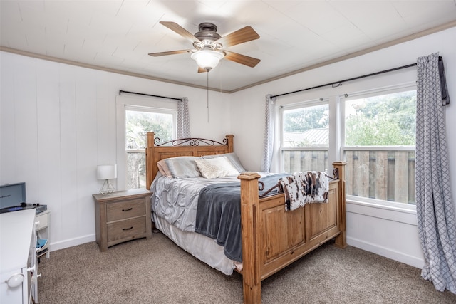 bedroom featuring ceiling fan, light carpet, and multiple windows