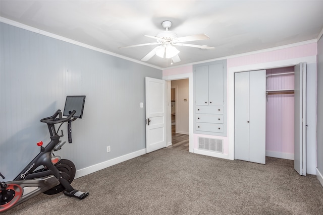 workout area featuring ornamental molding, ceiling fan, and carpet flooring