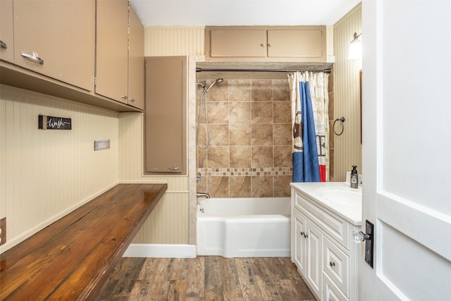 bathroom featuring vanity, wood walls, shower / bathtub combination with curtain, and hardwood / wood-style flooring