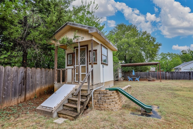 view of playground featuring a storage shed and a yard