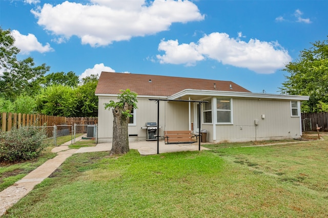 back of property with cooling unit, a patio area, and a yard