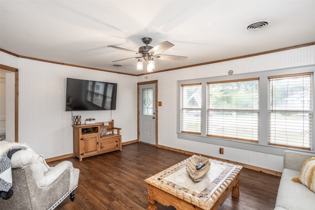 living room featuring ceiling fan, ornamental molding, dark hardwood / wood-style flooring, and a healthy amount of sunlight