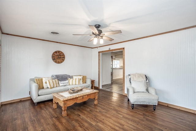 living room with ornamental molding, dark hardwood / wood-style flooring, and ceiling fan