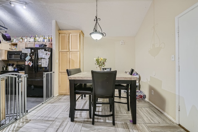 dining area with lofted ceiling