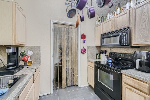 kitchen with black appliances and light brown cabinets