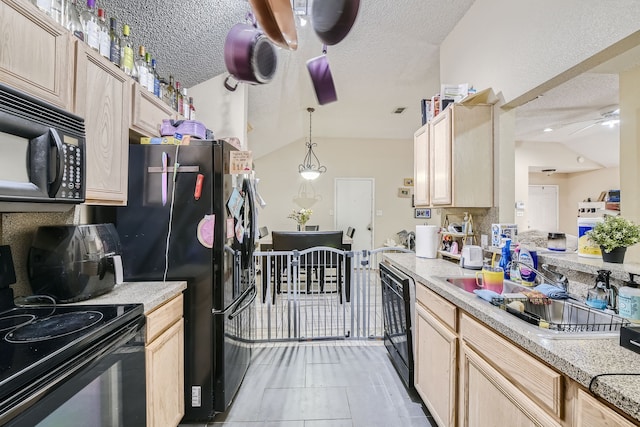 kitchen featuring black appliances, vaulted ceiling, and light brown cabinetry