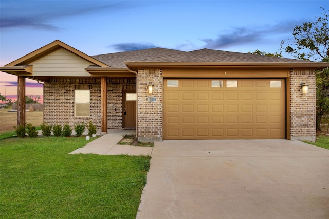 view of front of property featuring a lawn and a garage