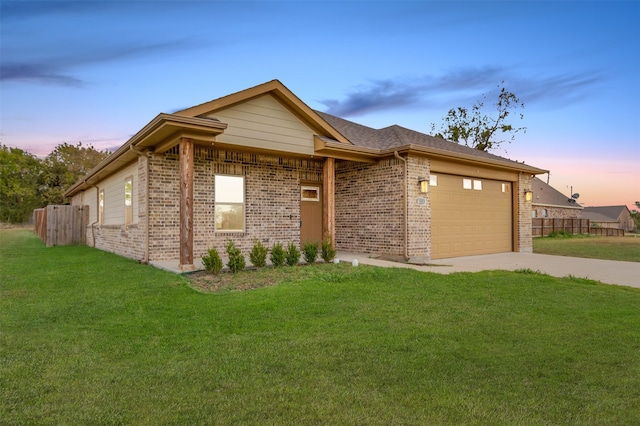 view of front of property featuring a garage and a lawn