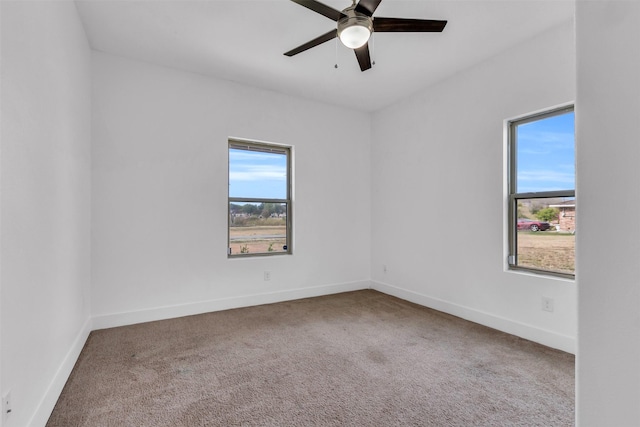 spare room featuring carpet floors and ceiling fan