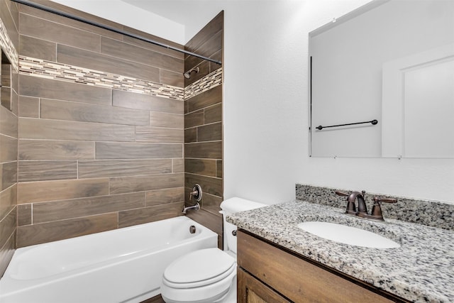 full bathroom with vanity, tiled shower / bath, and toilet