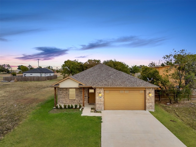 view of front of house featuring a garage and a lawn