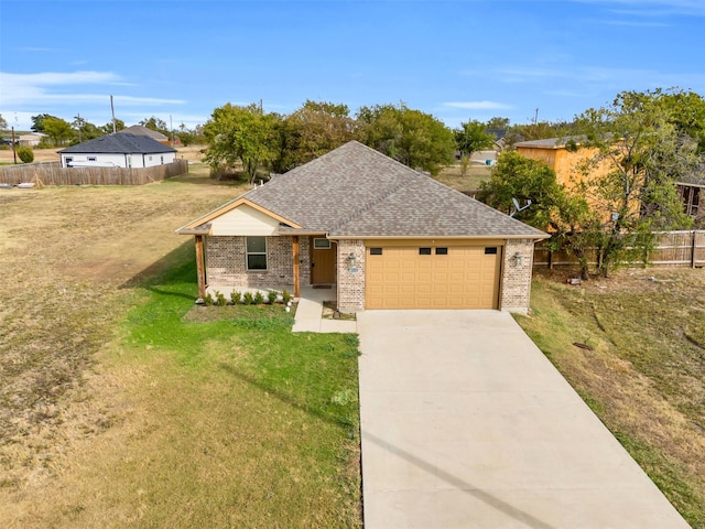 view of front of property with a garage and a front yard