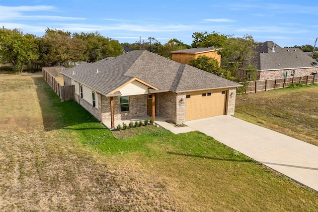 single story home featuring a garage and a front yard