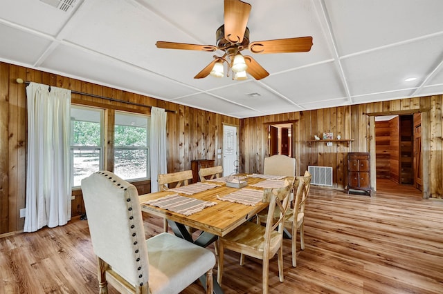 dining room with ceiling fan, coffered ceiling, and light wood-type flooring