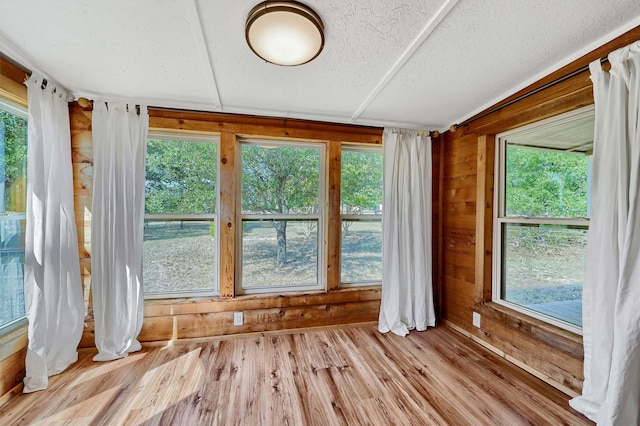 unfurnished sunroom featuring a healthy amount of sunlight