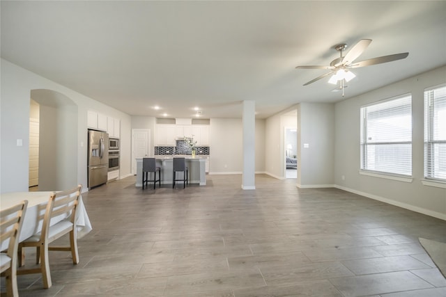 unfurnished living room with ceiling fan