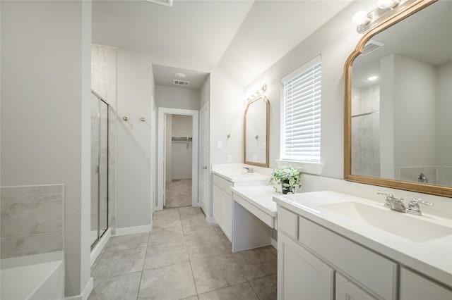 bathroom featuring vanity, a shower with shower door, and tile patterned floors