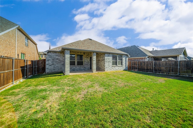 back of house with a yard and a patio area