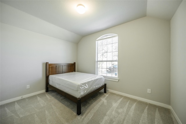 carpeted bedroom featuring vaulted ceiling