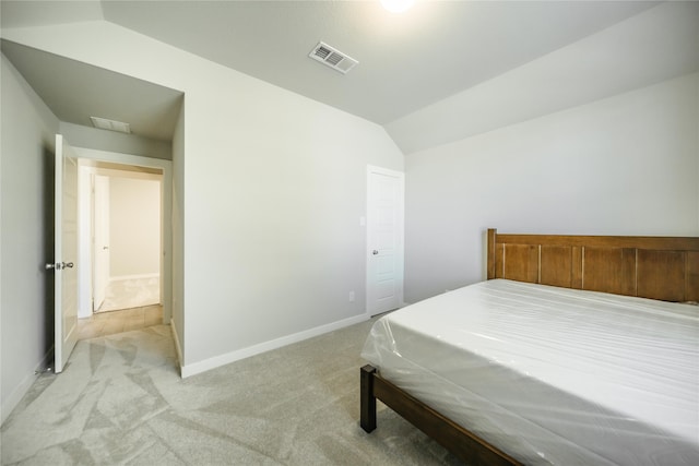 carpeted bedroom featuring lofted ceiling