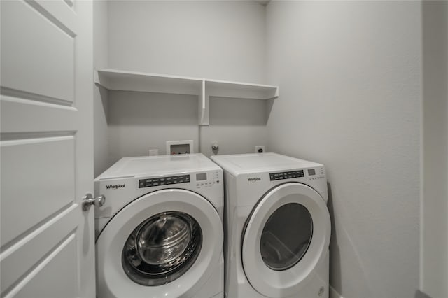 laundry area with independent washer and dryer