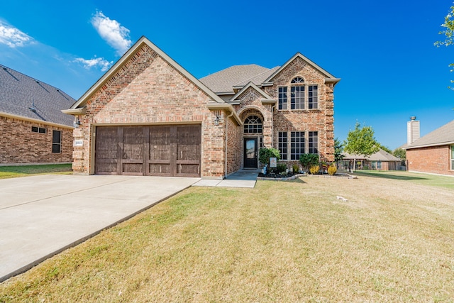 view of front facade featuring a garage and a front lawn