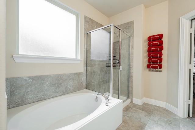 bathroom featuring independent shower and bath