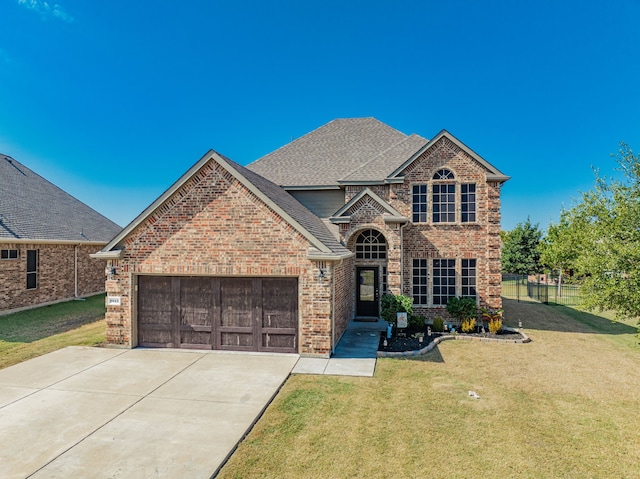 view of front facade featuring a garage and a front lawn