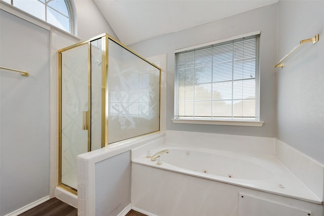 bathroom featuring vaulted ceiling, plus walk in shower, and hardwood / wood-style flooring