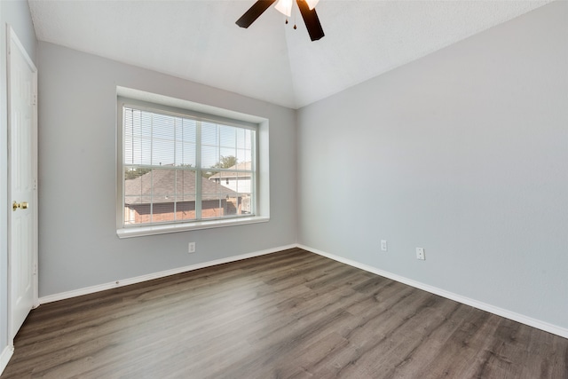 empty room featuring vaulted ceiling, ceiling fan, and dark hardwood / wood-style floors