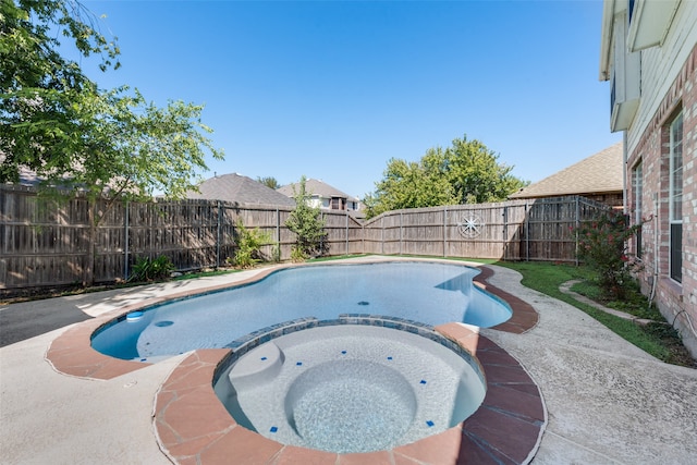 view of swimming pool with an in ground hot tub