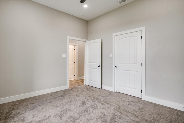 unfurnished bedroom with a closet and carpet flooring