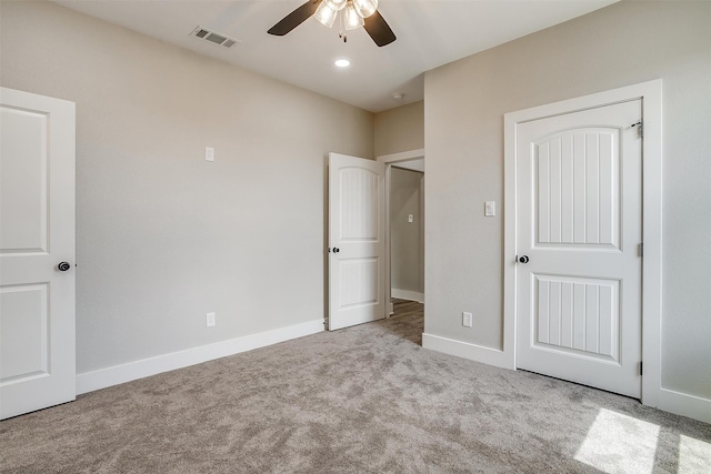 unfurnished bedroom with a closet, ceiling fan, and light colored carpet