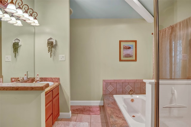 bathroom featuring tiled tub, vanity, and tile patterned flooring