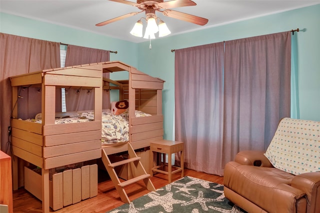 bedroom with light hardwood / wood-style floors and ceiling fan