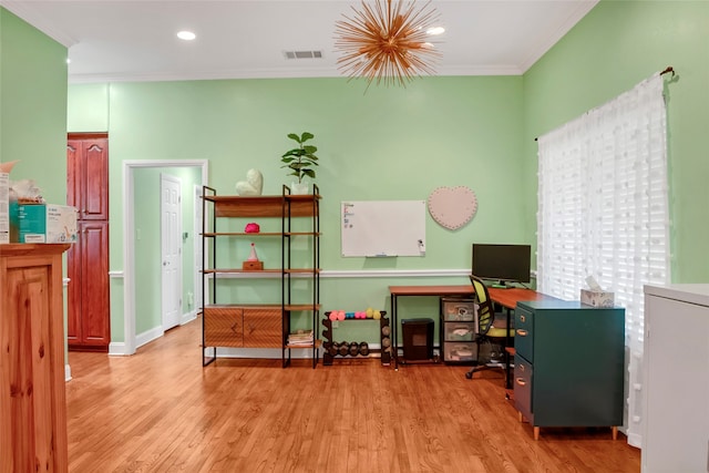 home office with light wood-type flooring and crown molding