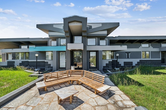 back of property featuring stucco siding