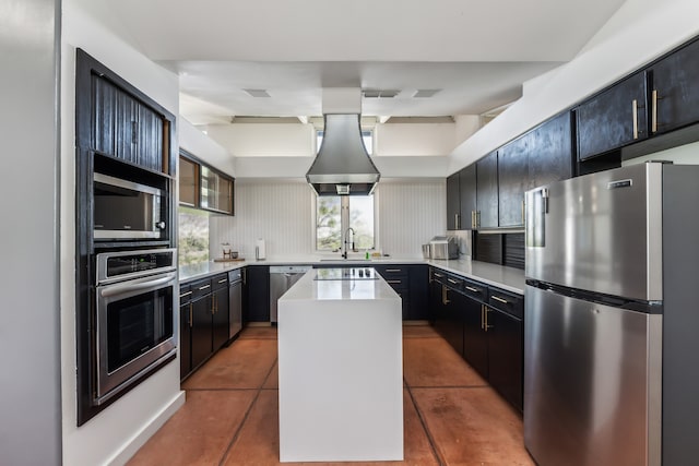 kitchen with a kitchen island, stainless steel appliances, tile patterned flooring, decorative backsplash, and light countertops