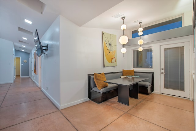 dining room with breakfast area, visible vents, baseboards, and finished concrete flooring