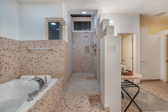 full bathroom with tiled bath, tile walls, and walk in shower