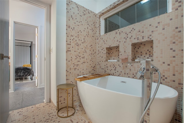 full bathroom featuring tile walls, a soaking tub, and tile patterned floors