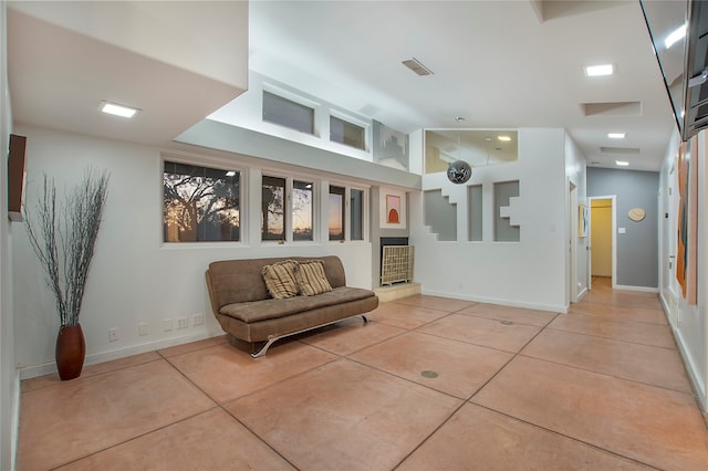 living area featuring tile patterned flooring, baseboards, and visible vents