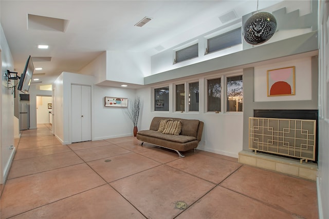 interior space featuring a fireplace, visible vents, and baseboards