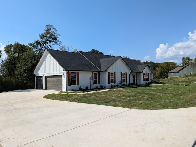 modern inspired farmhouse with a front lawn and a garage