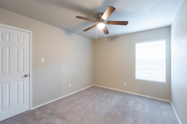 empty room featuring light carpet and ceiling fan